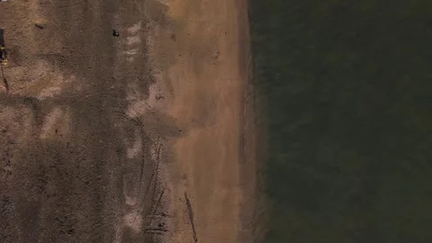 A beach with a body of water in the background Stock Footage 328387220