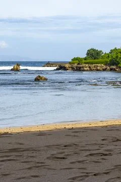 Beach with a body of water in the background Stock Photos