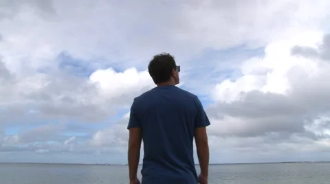 Beach Boy Looking Out Over Ocean Video stock 45618098