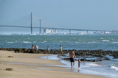 Beach with bridge across the bay Stock Photos