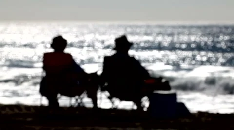 Beach bums 03 - silhouette rack focus Stock Footage 5087601