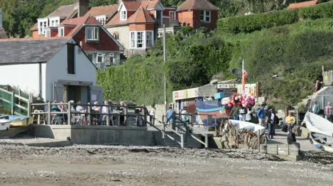 Beach cafe and people in a small fishing bay Stock Footage 57598701