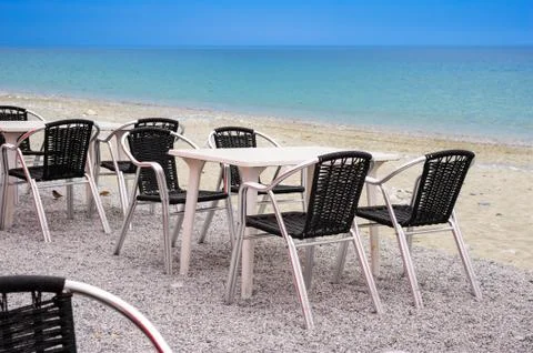 Beach cafe with empty tables and chairs Stock Photos