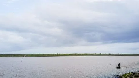 A beach with a calm water Stock Photos