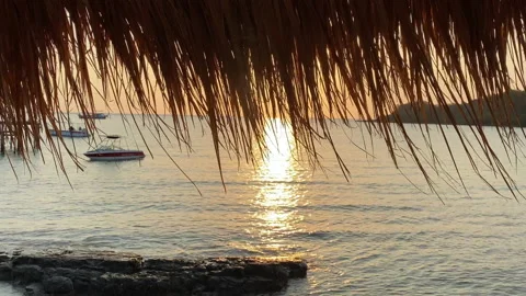 Beach canopy. Empty sandy beach and sea waves at sunset. 動画素材 197057380