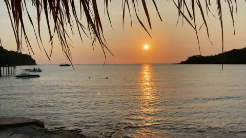 Beach canopy. Empty sandy beach and sea waves at sunset. 動画素材 197058413