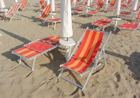 Beach chair on empty beach in the early morning Stock Photos