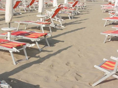 Beach chair on empty beach in the early morning Stock Photos
