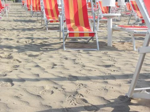 Beach chair on empty beach in the early morning Stock Photos
