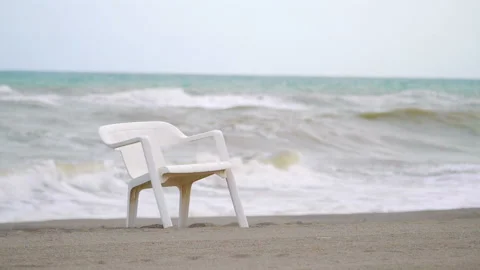 Beach chair on the empty closed beach during pandemic time in slow motion 180fps Stock Footage 145935636