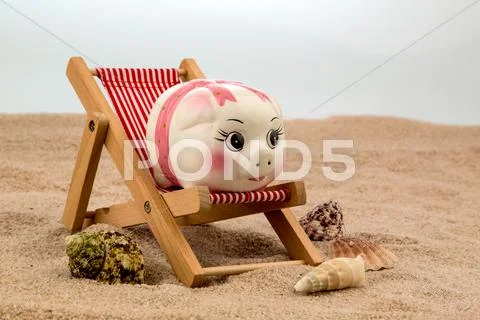 Beach chair with piggy bank Stock Photos