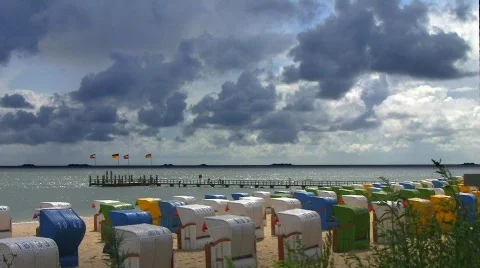 Beach chairs against cloudy sky Stock Footage 505059