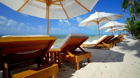 Beach Chairs and Umbrellas on Tropical Beach Stock Footage