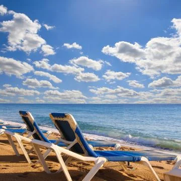 Beach chairs on beach Stock Photos