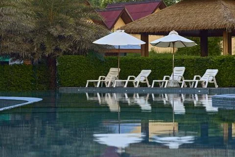 Beach chairs by the pool Stock Photos