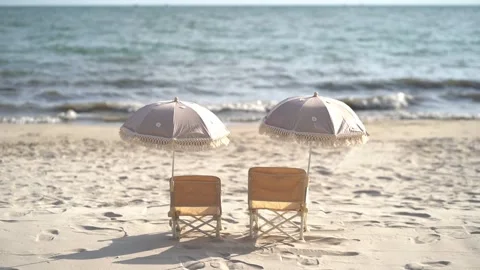 Beach Chairs Under a Parasol two matching beach chairs,  children's size Stock Footage 308168892