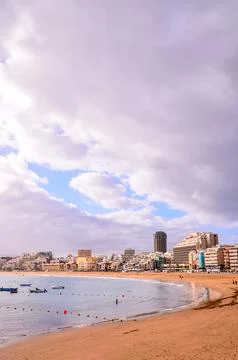 A beach with a city in the background Stock Photos