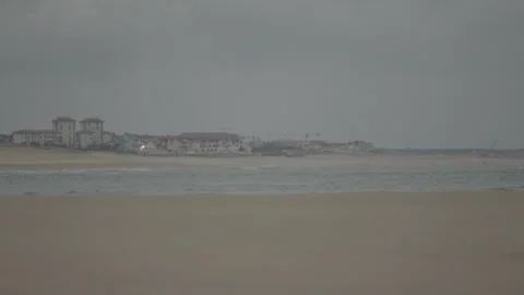 Beach with city under gray sky Video stock 346282089