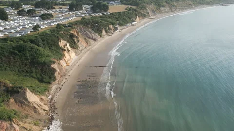 A beach with a cliff in the background Stock Footage 298272592