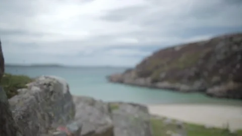 Beach cliff side pull focus from rocks to Beach sea Stock Footage 106907540