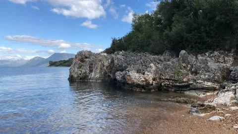 Beach with Cliffs and Blue Sky 4K Nature Water Vacation Holiday Stock Footage 107988535