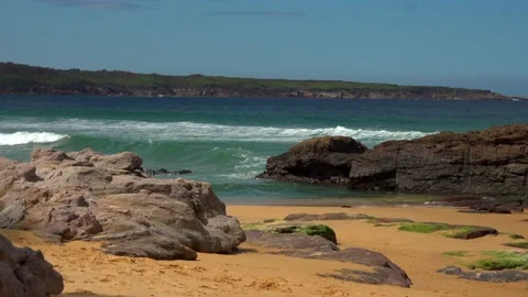Beach with cliffs and sea waves on a sunny day Stock Footage 131521118