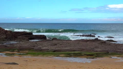 Beach with cliffs and sea waves on a sunny day Stock Footage 131521152