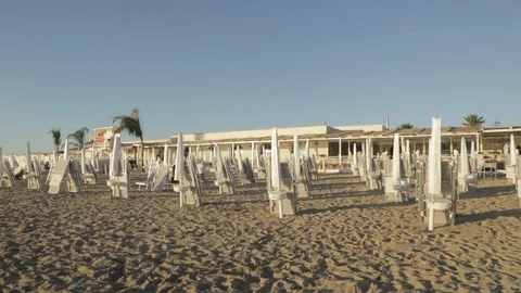 Beach with closed umbrellas landscape Stock Footage 88170941