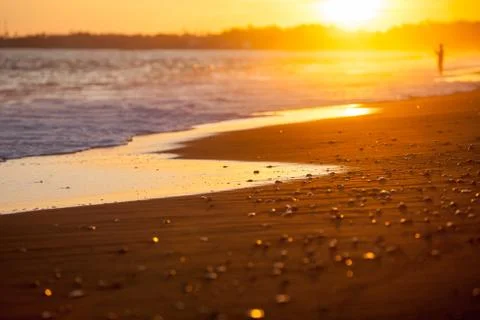 Beach closeup in the rays of the setting sun Stock Photos