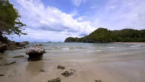 Beach with cloudy blue sky and rocky mountains Stock Footage 110716261