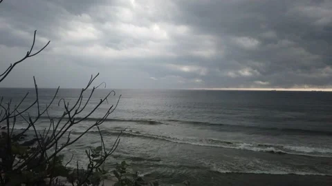 Beach on cloudy evening with heavy tides From a hill with traffic natural sounds Stock Footage 138487300