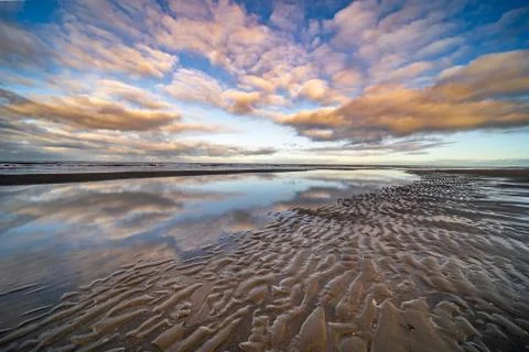 The beach, the cloudy sky and the shore lin Stock Photos