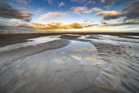 The beach, the cloudy sky and the shore lin Stock Photos