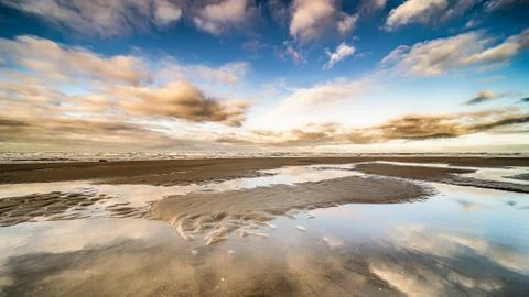 The beach, the cloudy sky and the shore lin Stock Photos