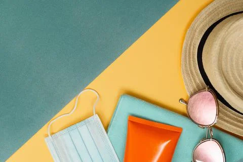 Beach composition with straw hat, covid mask and sunglasses Stock Photos