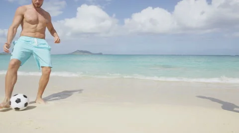 Beach couple having fun on playing soccer football - healthy lifestyle vacation Stock Footage 46955874