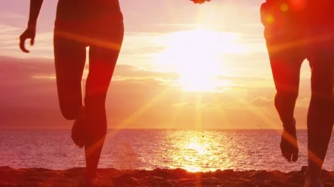 Beach couple holding hands on beach enjoying sunset running having fun on travel Stock Footage 79899727