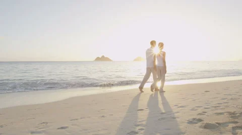 Beach couple walking happy by sunrise on vacation  on beautiful summer beach Video stock 48342181
