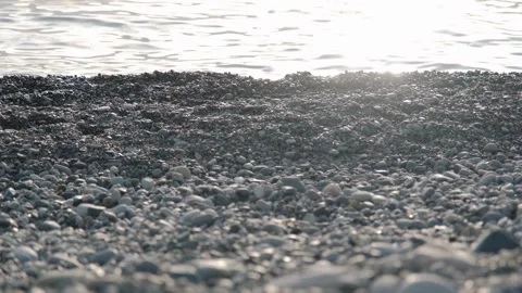 Beach covered with small pebbles by sea with rolling waves Stock-Footage 150819120