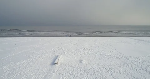 Beach covered with snow drone view and biker 스톡 동영상 127983273