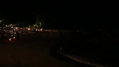 Beach crowd watches fire show at Klong Muang Beach Stock Footage 336714907