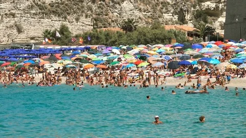 Beach crowded with bathers on a hot summer day in Italy, Tropea Stock Footage 77774276
