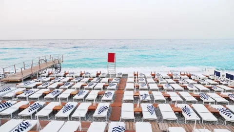 Beach deck chair on a sandy beach by the turquoise sea. Panoramic lounger with Stock Footage 210851399