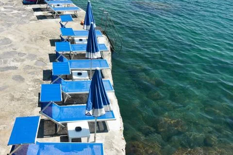 Beach with deck-chairs Stock Photos