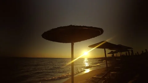 Beach with deck chairs under sun umbrella Stock Footage 212984450