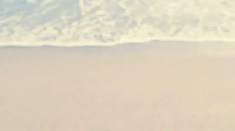 On the Beach - defocused shot of waves rolling on the beach - seamless loop Stock-Footage 64655264