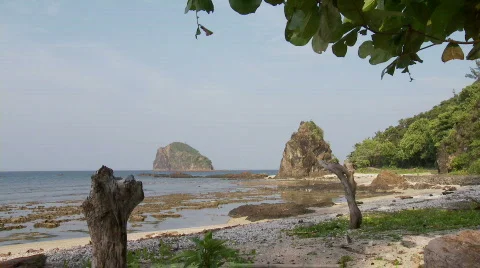 Beach during lower tide with huge and beautiful rock formation in the   Stock Footage 555706