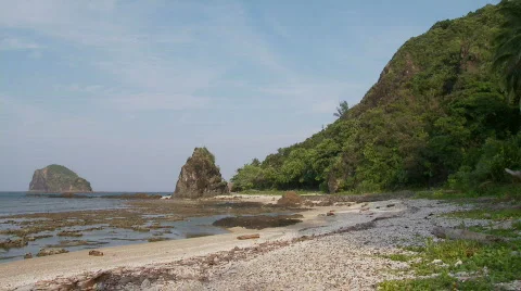 Beach during lower tide with huge and beautiful rock formation in the   Stock Footage 555728