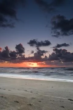 A beach during sunset with glowing sky Stock Photos