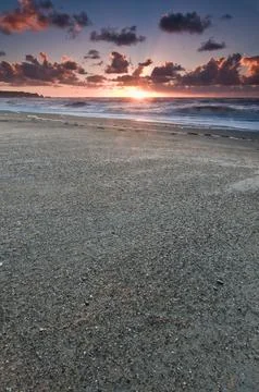 A beach during sunset with glowing sky Stock Photos